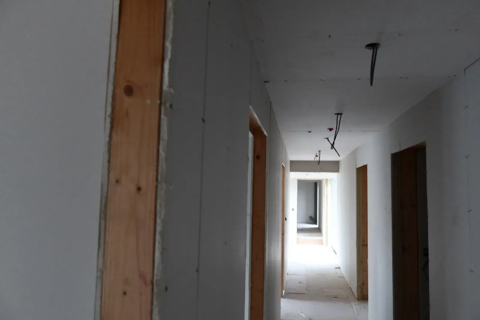 Newly installed plasterboard in a hallway during an internal wall insulation and retrofit project in South Wales