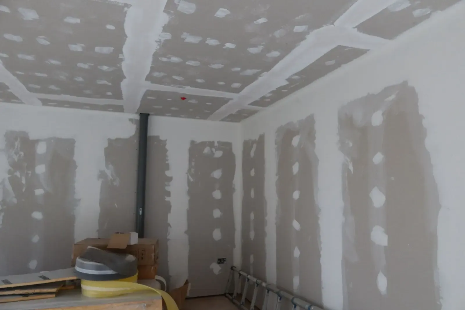 Taped and jointed plasterboard ceiling and walls during an internal wall insulation finishing process