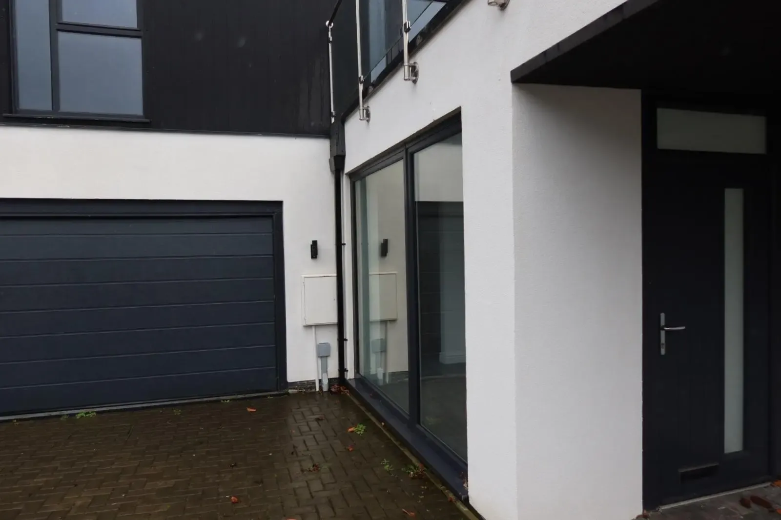 A modern home exterior featuring pristine white silicone rendering and an insulated render system installed by Global Energy Insulation in South Wales